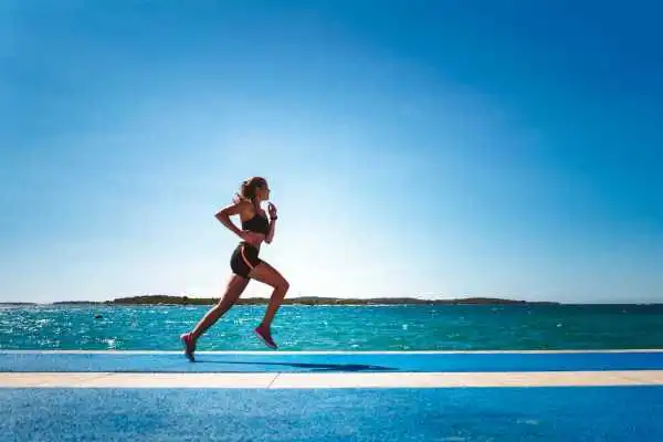 Woman running showing strong leg muscle Hamilton